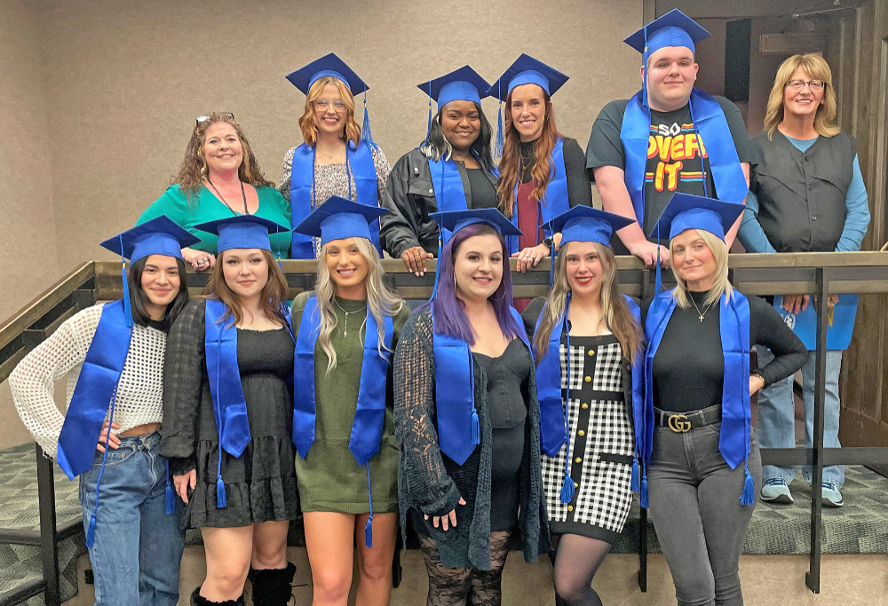 The 2023 Lorain County JVS Adult Career Center Cosmetology class proudly smiles with their instructors.