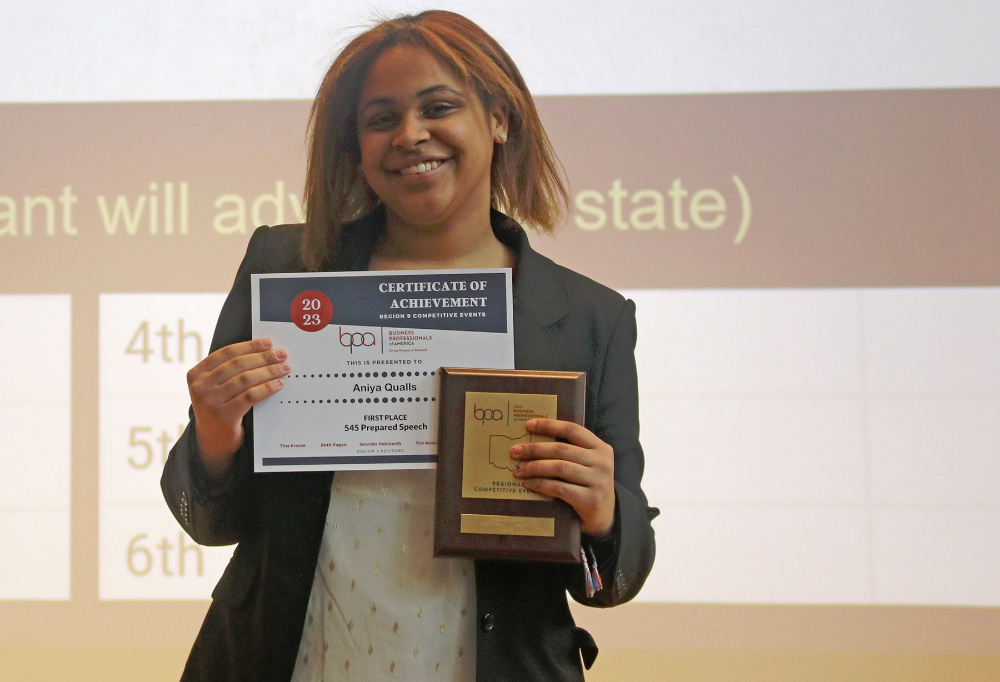 Aniya Qualls, (Midview), smiles with her first award and certificate for the Prepared Speech event.