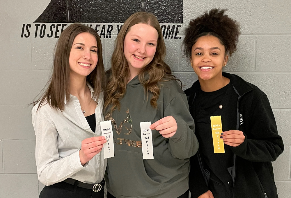 From left: Lorain County JVS Allied Health Science juniors, Marianna Frank (Oberlin), Tatum Porter (Elyria) and Joyce Stallard (Wellington) smile at the HOSA-Future Health Professionals competition with their award ribbons.