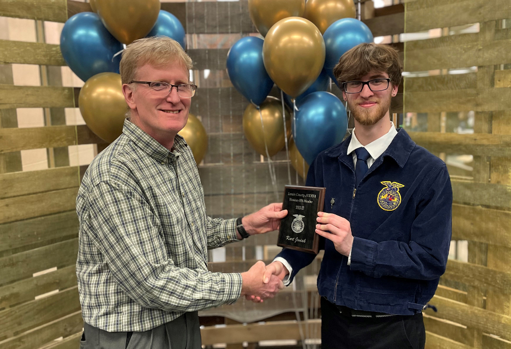 Kurt Joviak, LCJVS Science Instructor, receives an Honorary FFA Member plaque from Kevin Daviduk (Amherst)