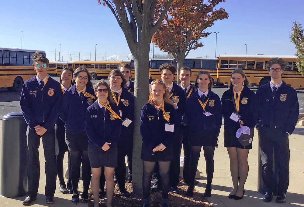 LCJVS FFA Chapter Members smile in their blue and gold jackets outside the National Convention event