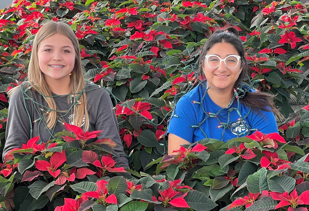 Landscape and Greenhouse Management students Devon Wiles (Firelands), and Kirby Herrera (Columbia) are surrounded by poinsettias in the LCJVS greenhouse. 