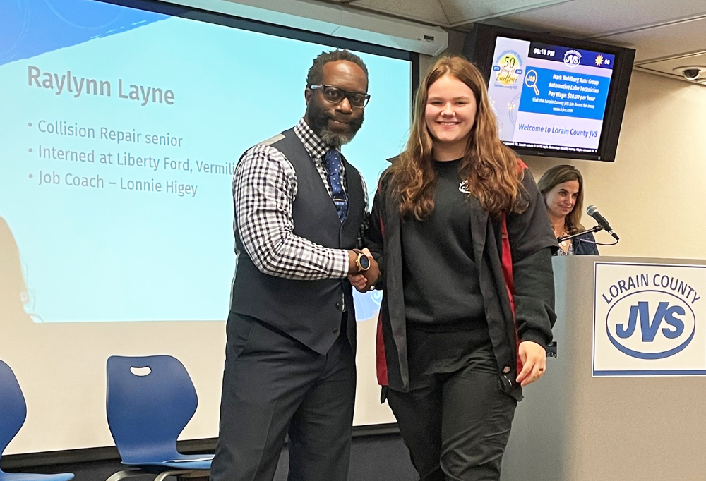 Raylynn Layne, Collision Repair senior (Midview) shakes hands with Dr. Faircloth at the LCJVS Summer Internship Celebration before receiving her certificate of completion.