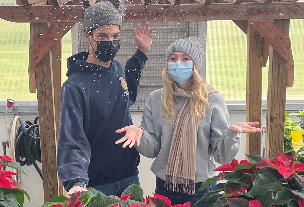 Lorain County JVS Landscape and Greenhouse Management seniors, Isaiah Allen (Clearview) and Kylee Gill (Keystone) smile in the greenhouse under some festive snow!