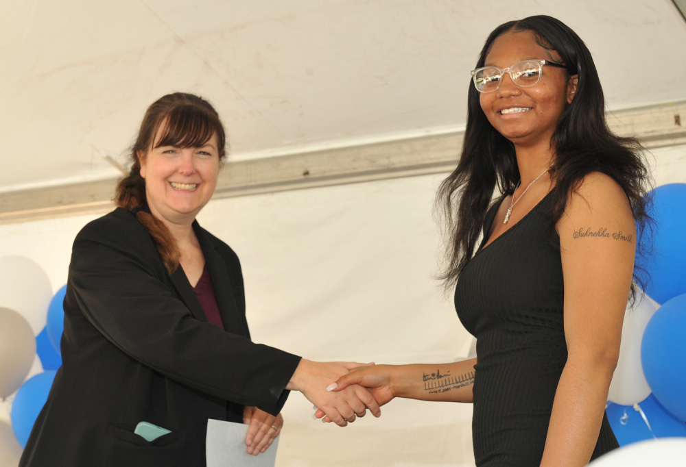  Teressah Smith Clearview) shakes hands with Lorain County JVS High School Principal, Tina Pelto, as she receives one of her two scholarship certificates. 