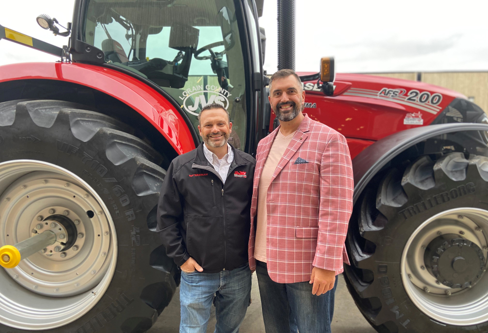 Lorain County JVS Career Services Specialist, Mathias Hauck (right) talks with Tom Stannard about the Wellington Implement donation and business partnership. 