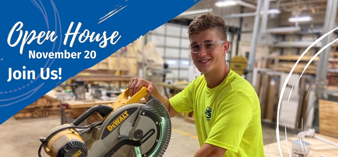 Male carpentry student by saw smiling. Open House November 20. Join us!