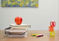 Apple on top of books with ABC blocks